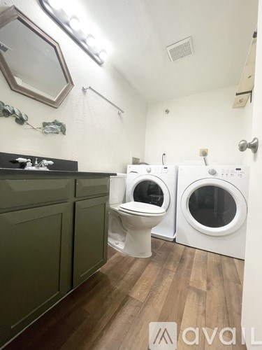 A bathroom with a washer and dryer.