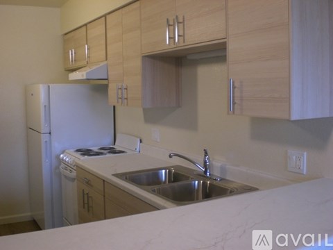 A white shelf unit sits in a narrow hallway.