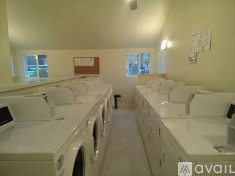 A row of washing machines in a laundromat.