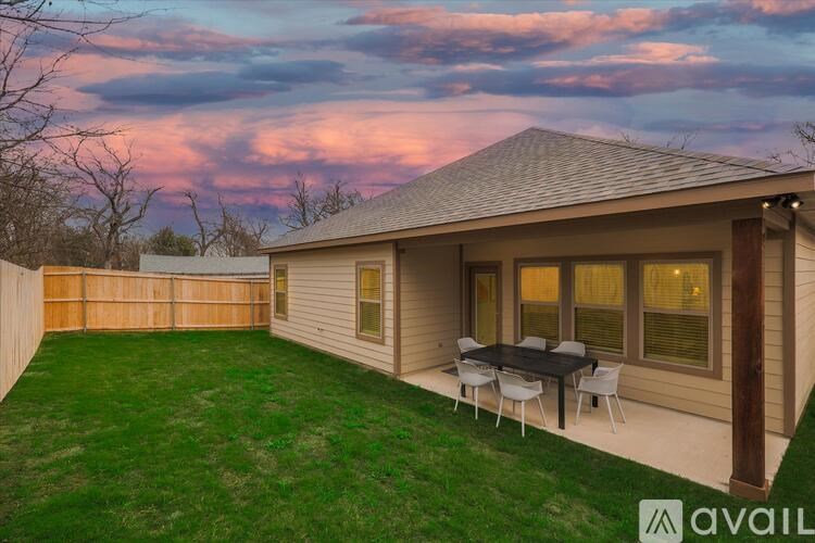 A house with a patio table and chairs is available for rent.