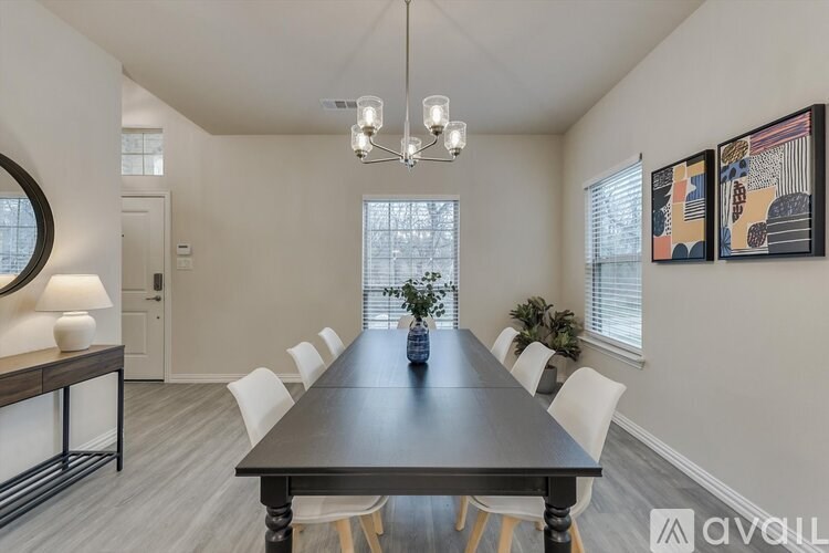 A dining room with a long table and chairs.