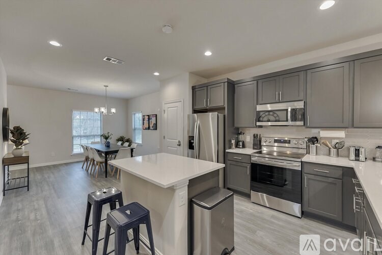 A modern kitchen with a dining table and chairs.