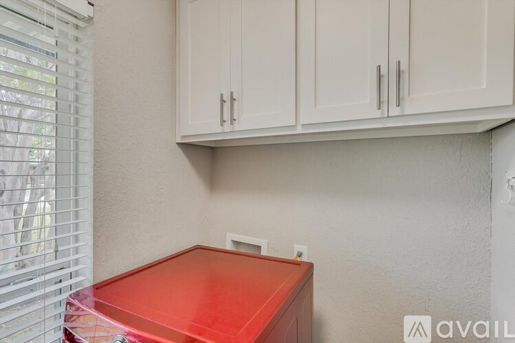 A red box sits on a white countertop in a kitchen.