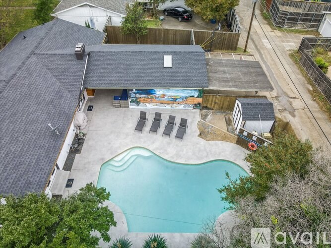 A backyard with a pool and a shed.