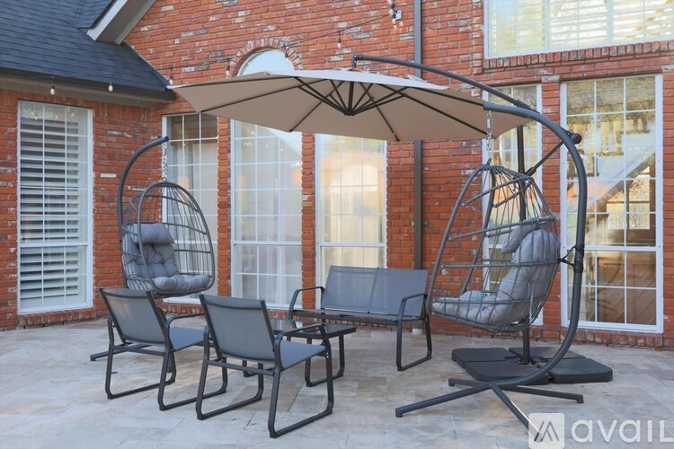 A patio set with a white umbrella is available for purchase.