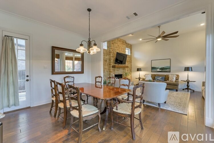 A dining room with a wooden table and chairs.