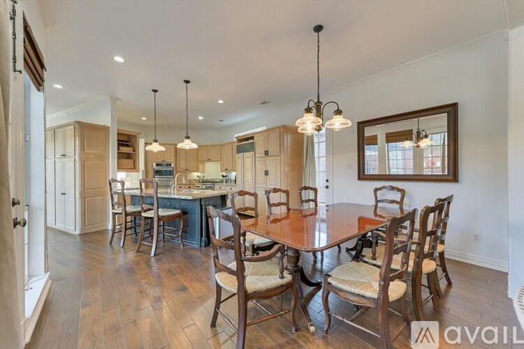A dining room with a table set for six.