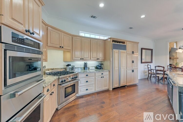 A kitchen with wooden cabinets and stainless steel appliances.