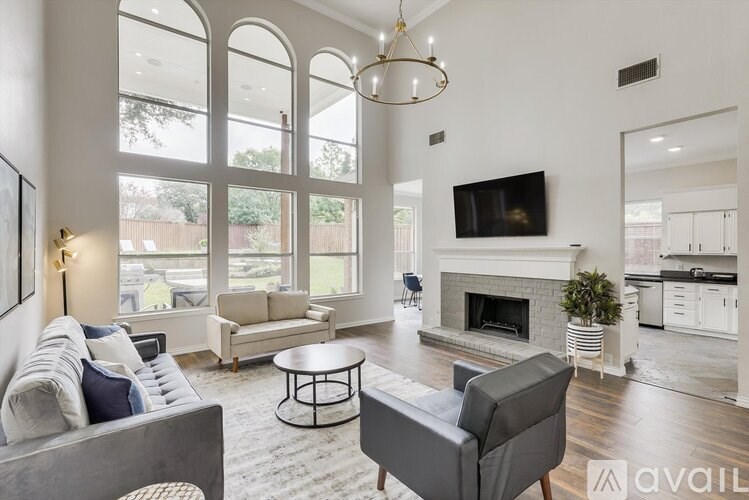 A living room with a grey couch, a coffee table, and a fireplace.