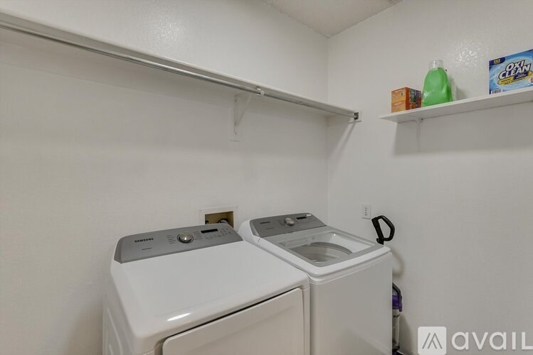 A small laundry room with a washer and dryer.