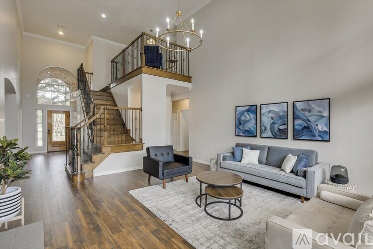 A living room with a staircase and a couch.