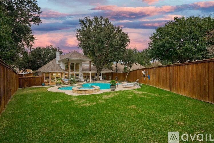 A backyard with a pool and a house.