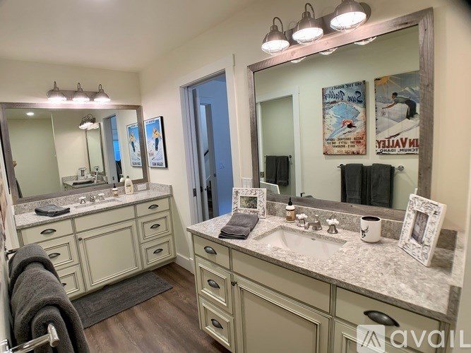 A bathroom with a large mirror and a sink.