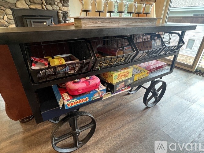 A black metal cart with a red box labeled "Trouble" on it.