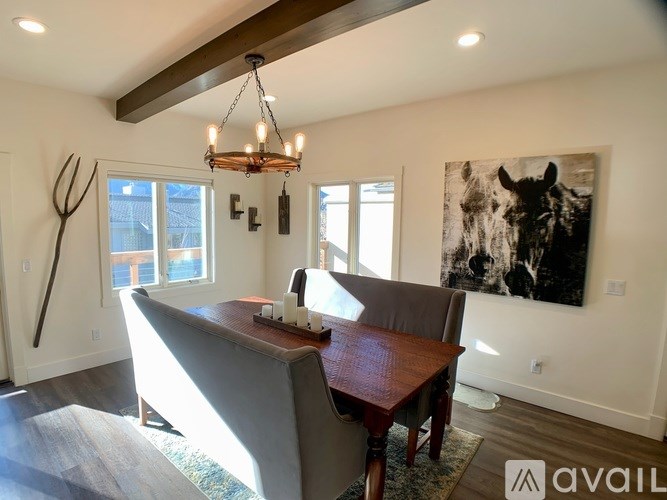 A modern dining room with a wooden table and chairs.