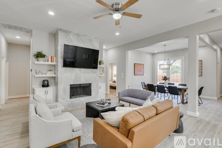 A living room with a fireplace, a television, and a couch.