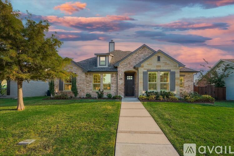 A house with a stone facade and a black door is shown with a sidewalk leading to it.