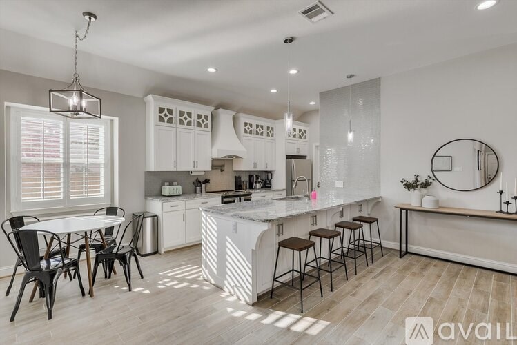 A modern kitchen with a dining table and chairs.