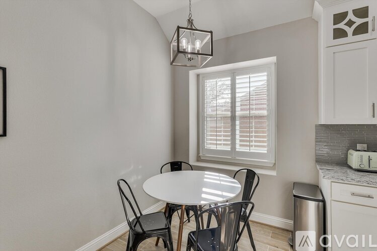 A dining area with a table and chairs.