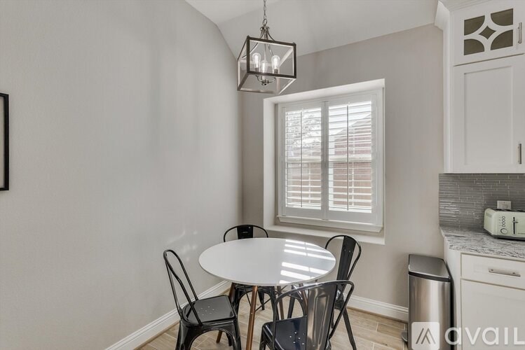 A dining area with a table and chairs.