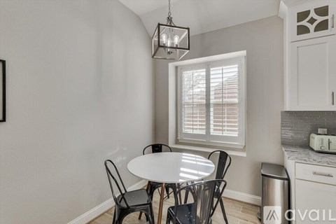 A dining area with a table and chairs.
