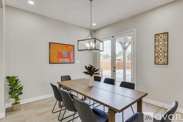 A dining room with a wooden table and chairs.