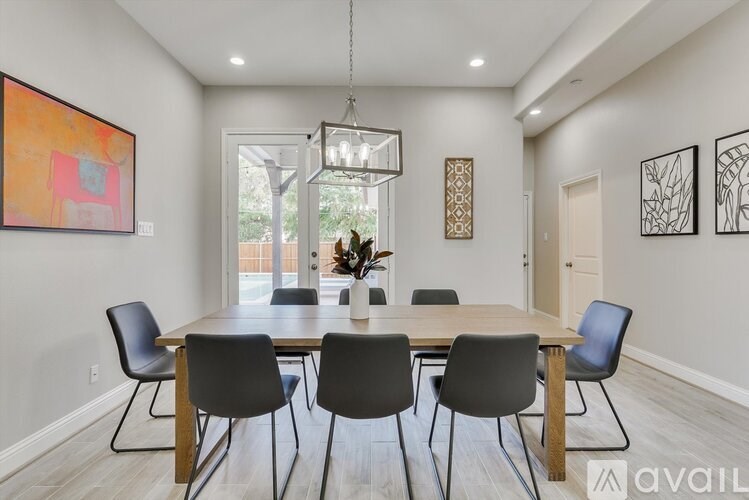 A dining room with a wooden table and chairs.