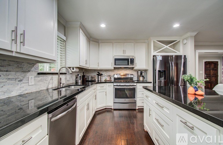 A bathroom with a toilet, sink, and mirror.