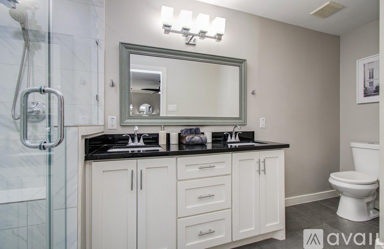 A bedroom with a bed, nightstand, and a ceiling fan.