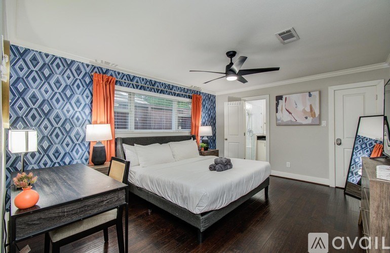 A living room with a grey sofa, a wooden coffee table, and a television on a wooden cabinet.