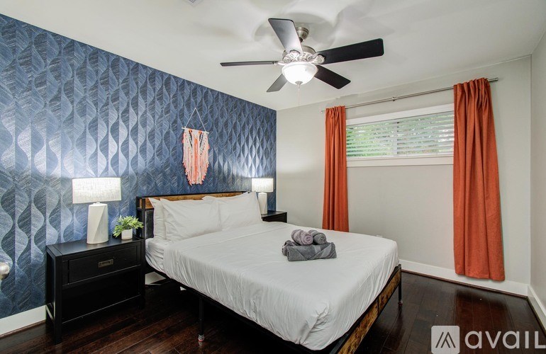 A basketball hoop stands in the middle of a driveway.