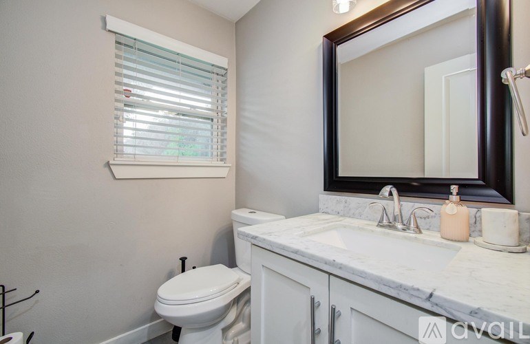 A house with a lawn and a walkway leading to the front door.