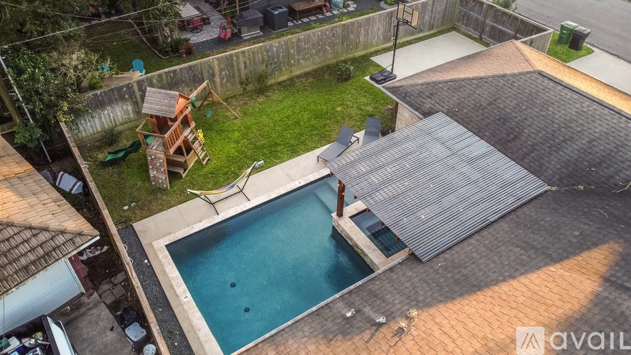 A small backyard with a pool and a deck.