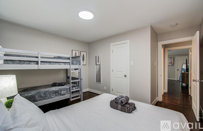 A bird's eye view of a residential area with a swimming pool and a road.