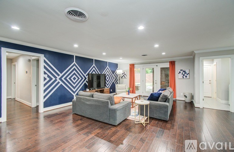 A dining room with a wooden table and chairs.