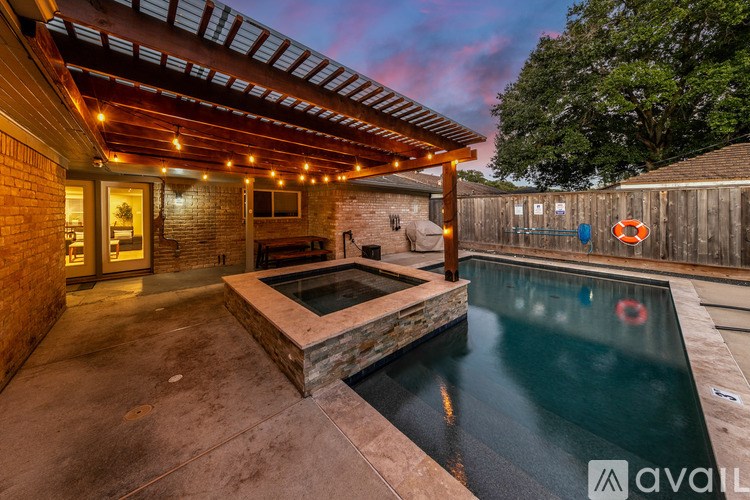 A pool with a hot tub in the middle of it.