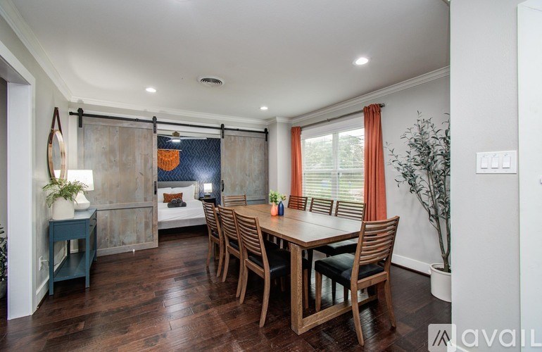 A modern kitchen with stainless steel appliances and white cabinets.