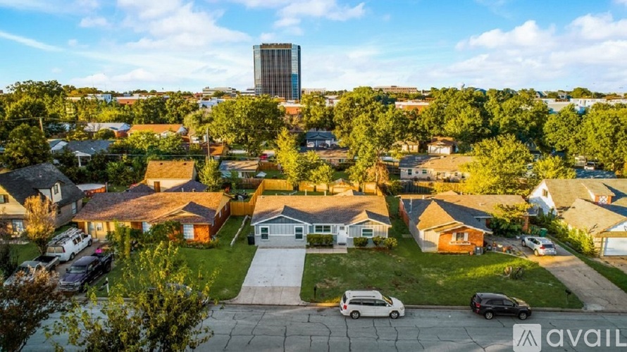 A suburban neighborhood with houses and a tall building in the background.