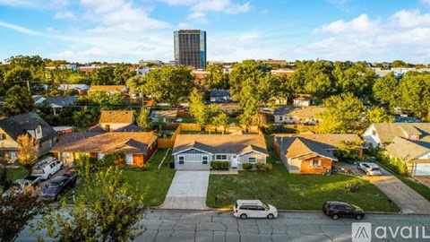 A suburban neighborhood with houses and a tall building in the background.