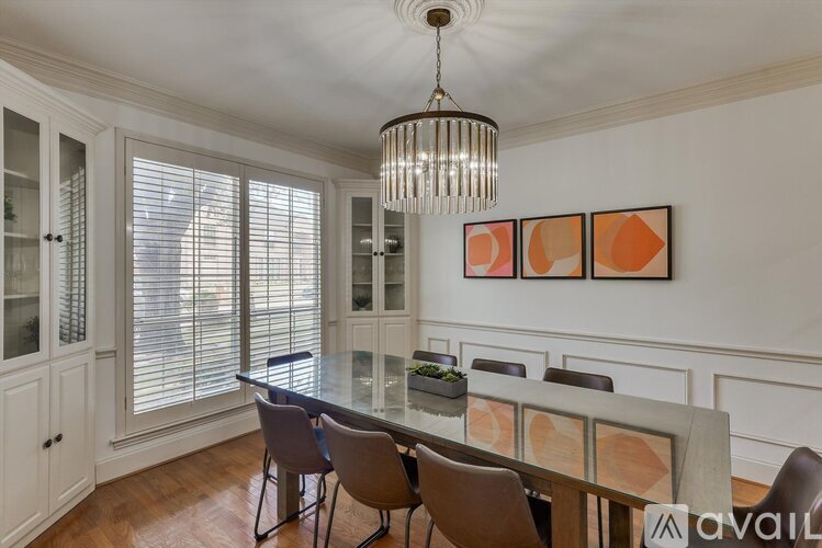 A dining room with a table set for four.