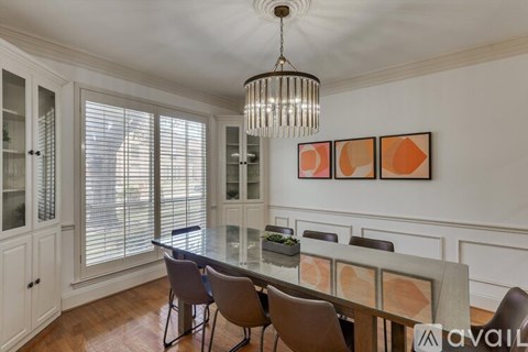 A dining room with a table set for four.