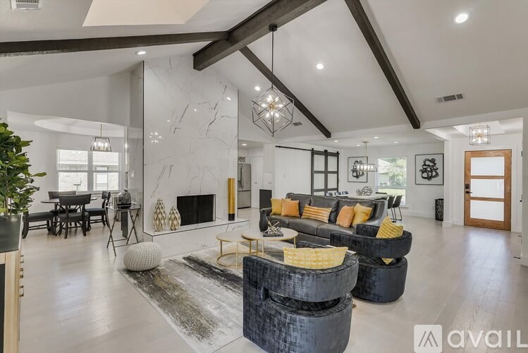 A modern living room with a fireplace and a large mirror on the wall.