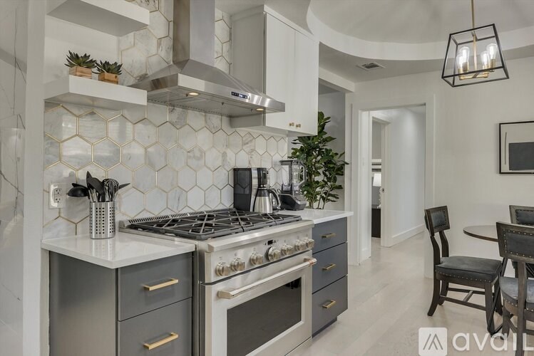 A kitchen with a white countertop and a black stove top oven.