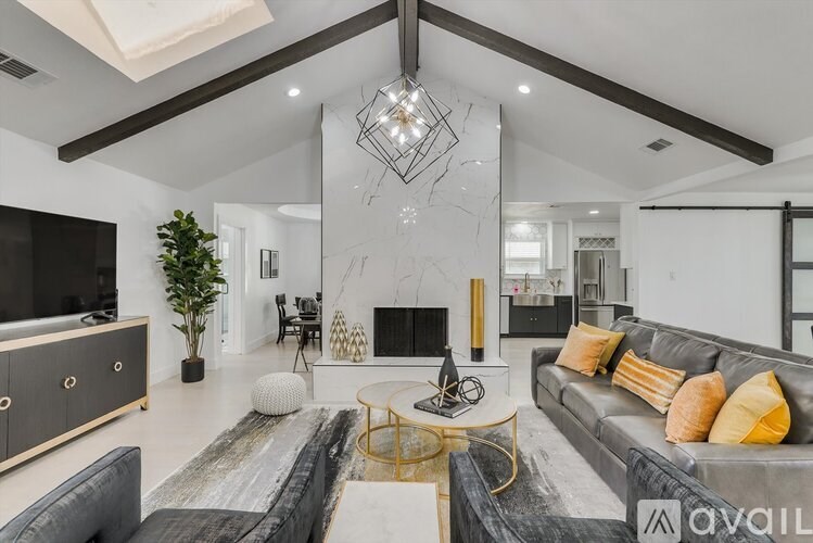 A modern living room with a grey sofa and a wooden coffee table.