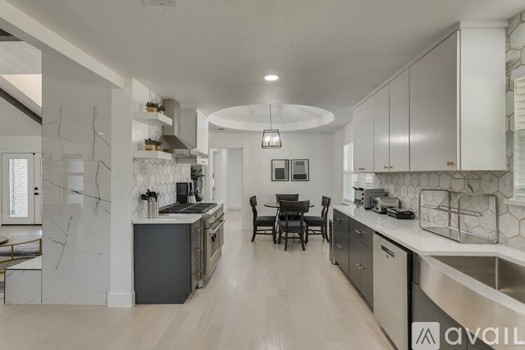 A modern kitchen with a dining area in the middle.