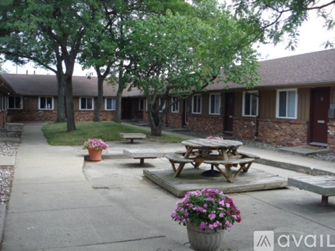 A courtyard with a picnic table and potted plants.