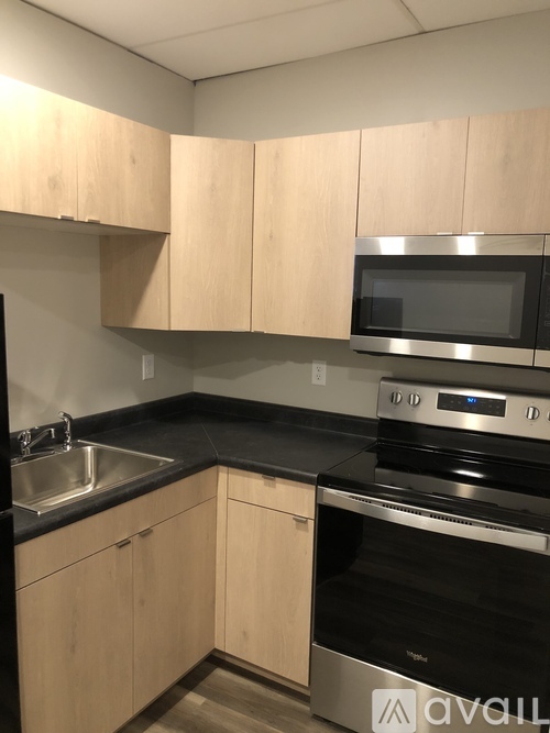A kitchen with wooden cabinets and stainless steel appliances.