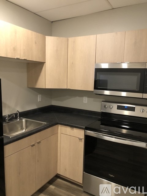 A kitchen with wooden cabinets and stainless steel appliances.
