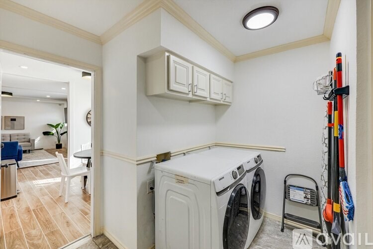 A small laundry room with a washer and dryer.