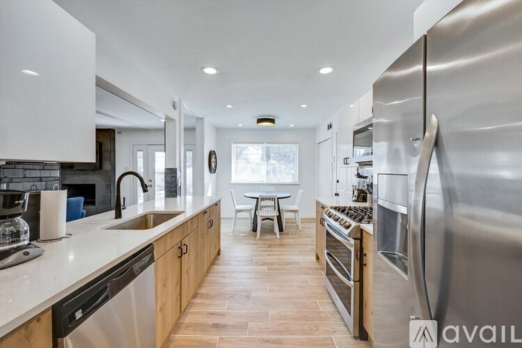 A modern kitchen with stainless steel appliances and wooden cabinets.